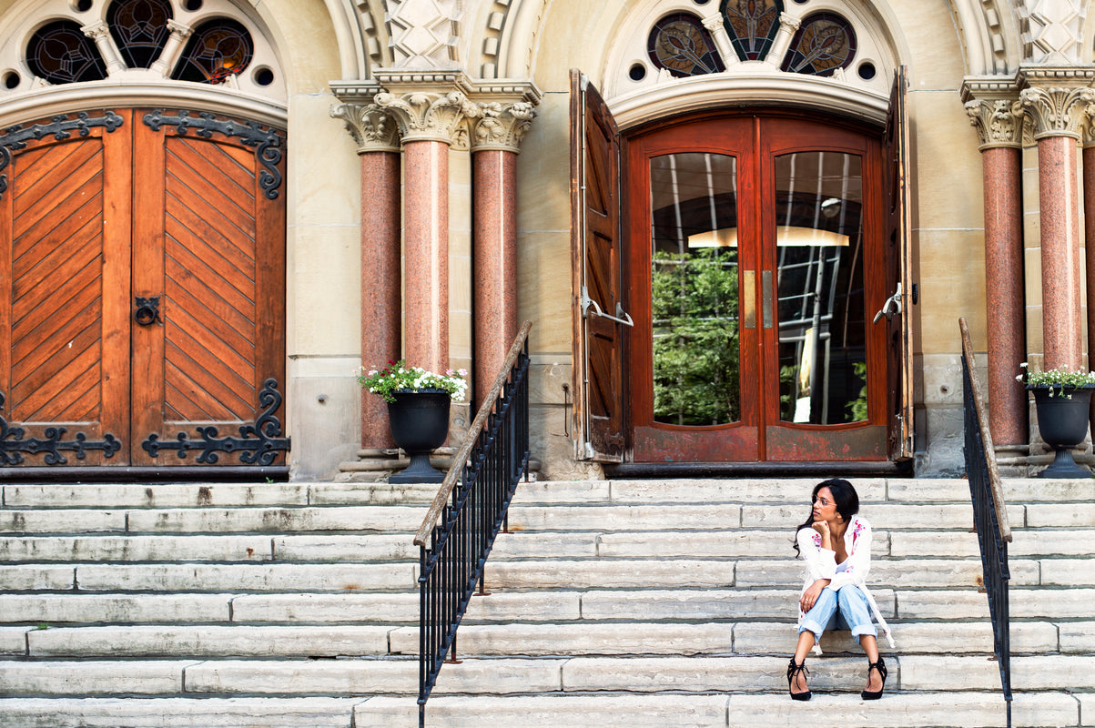Hillorama - Woman sits in front of a church thinking. This section of Hillorama caters to those interested in apparel & accessories about Mythological and Theological topics.